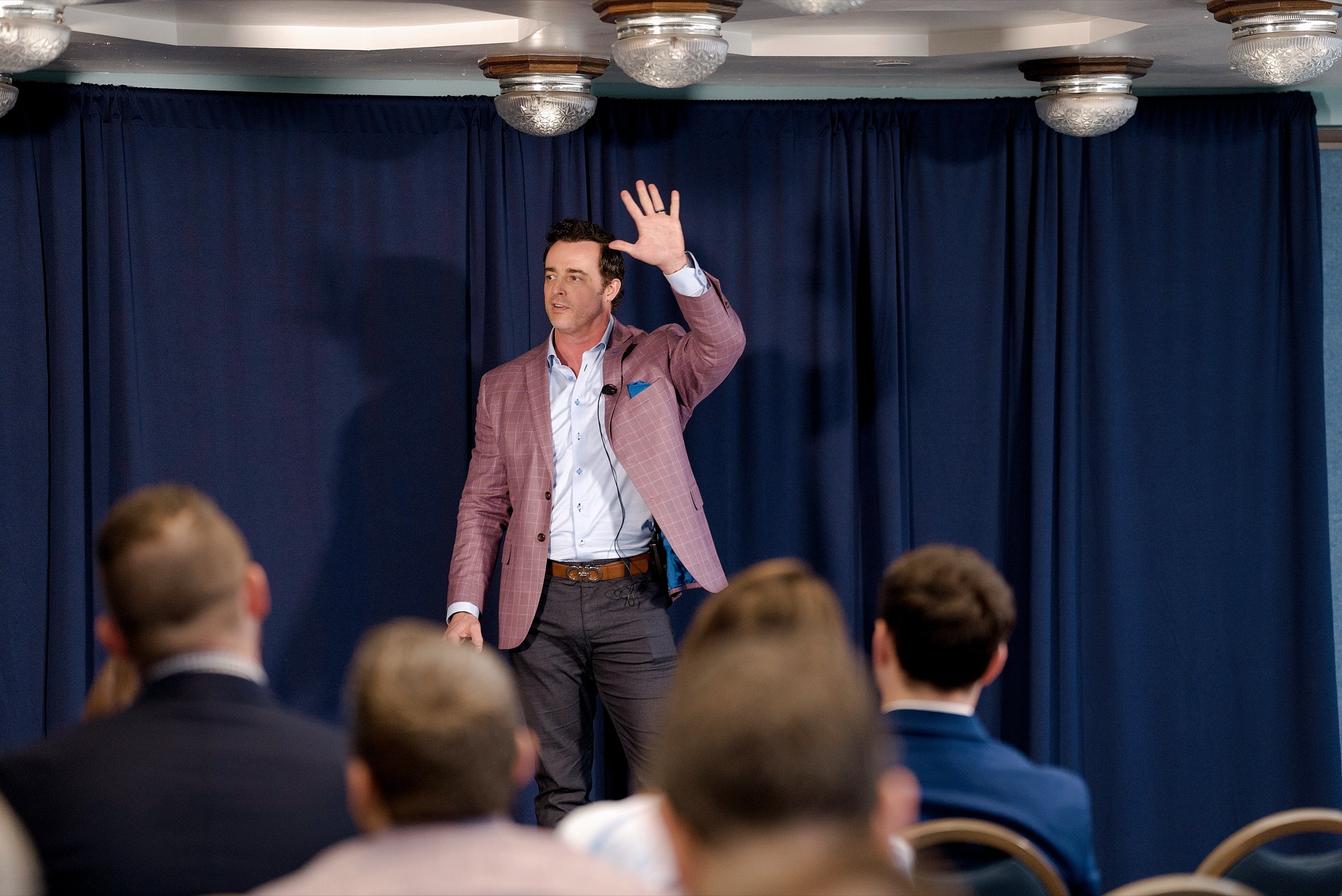 An Ambassador teaching from the stage to a seated room at the DC Summit